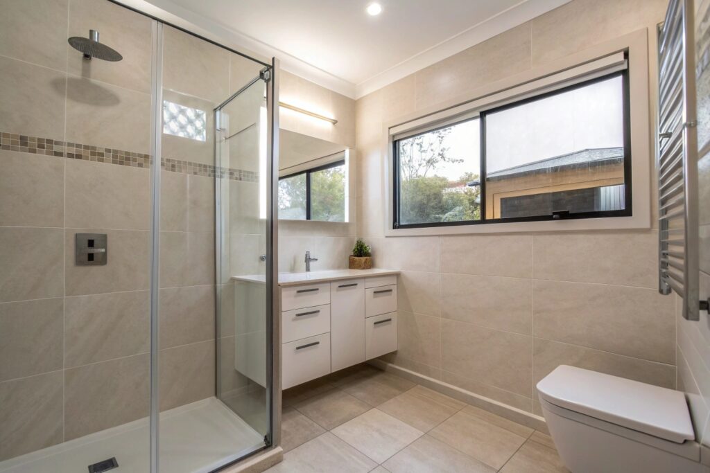 Compact ensuite renovation with space-saving design and large-format tiles in Townsville
